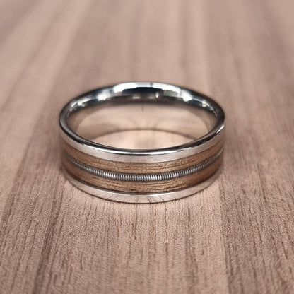 Stainless steel and walnut ring with guitar string inlay