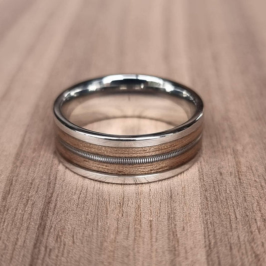 Stainless steel and walnut ring with guitar string inlay