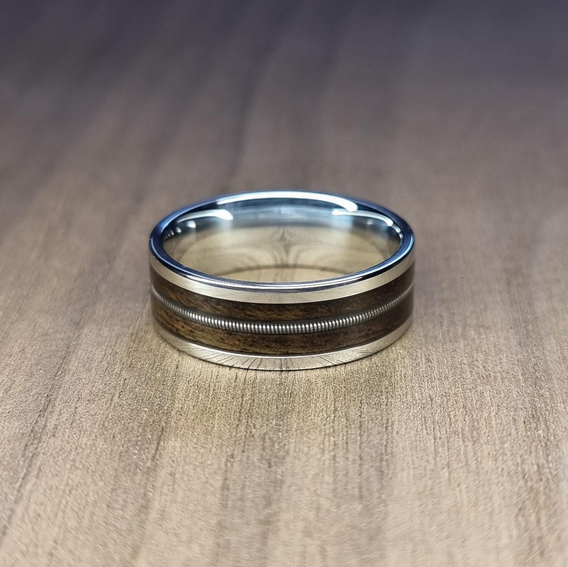 Stainless steel and smoked eucalyptus with guitar string inlay ring