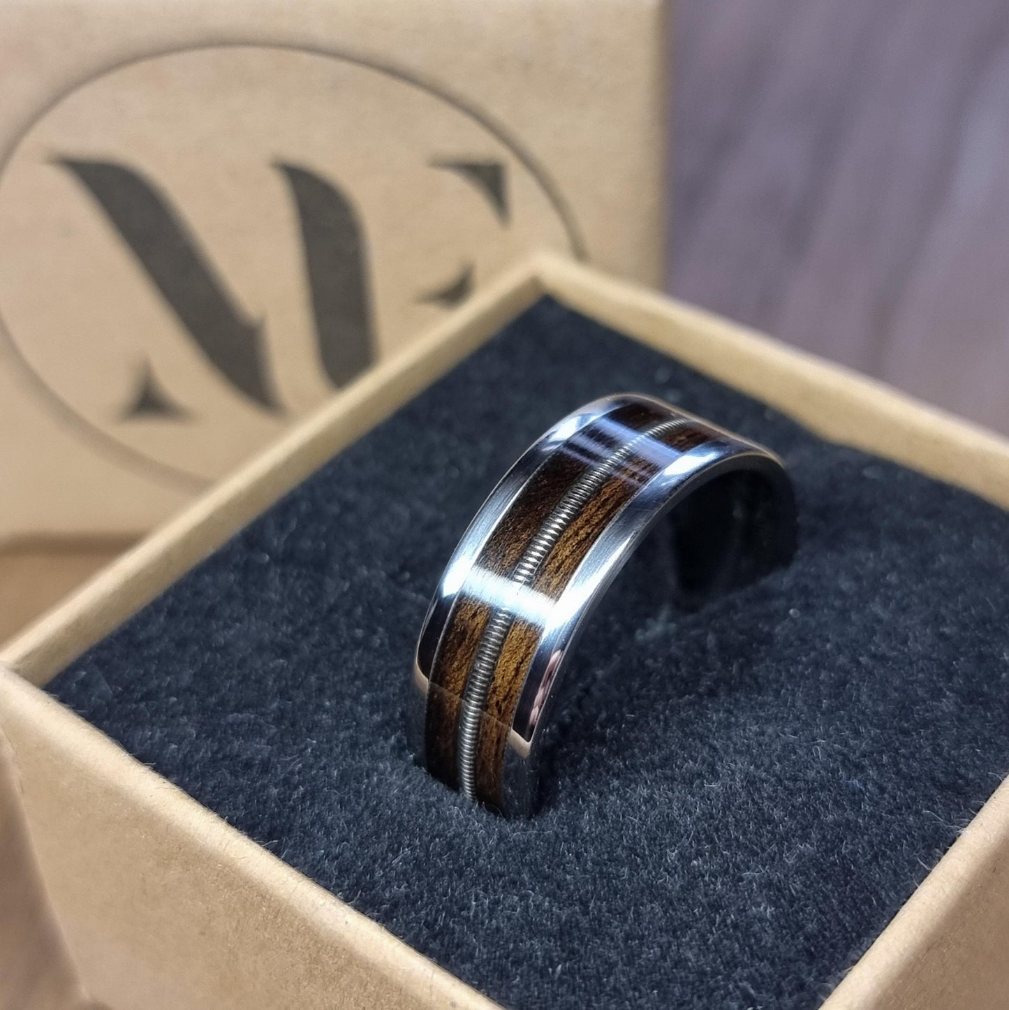 Stainless steel and smoked eucalyptus with guitar string inlay ring