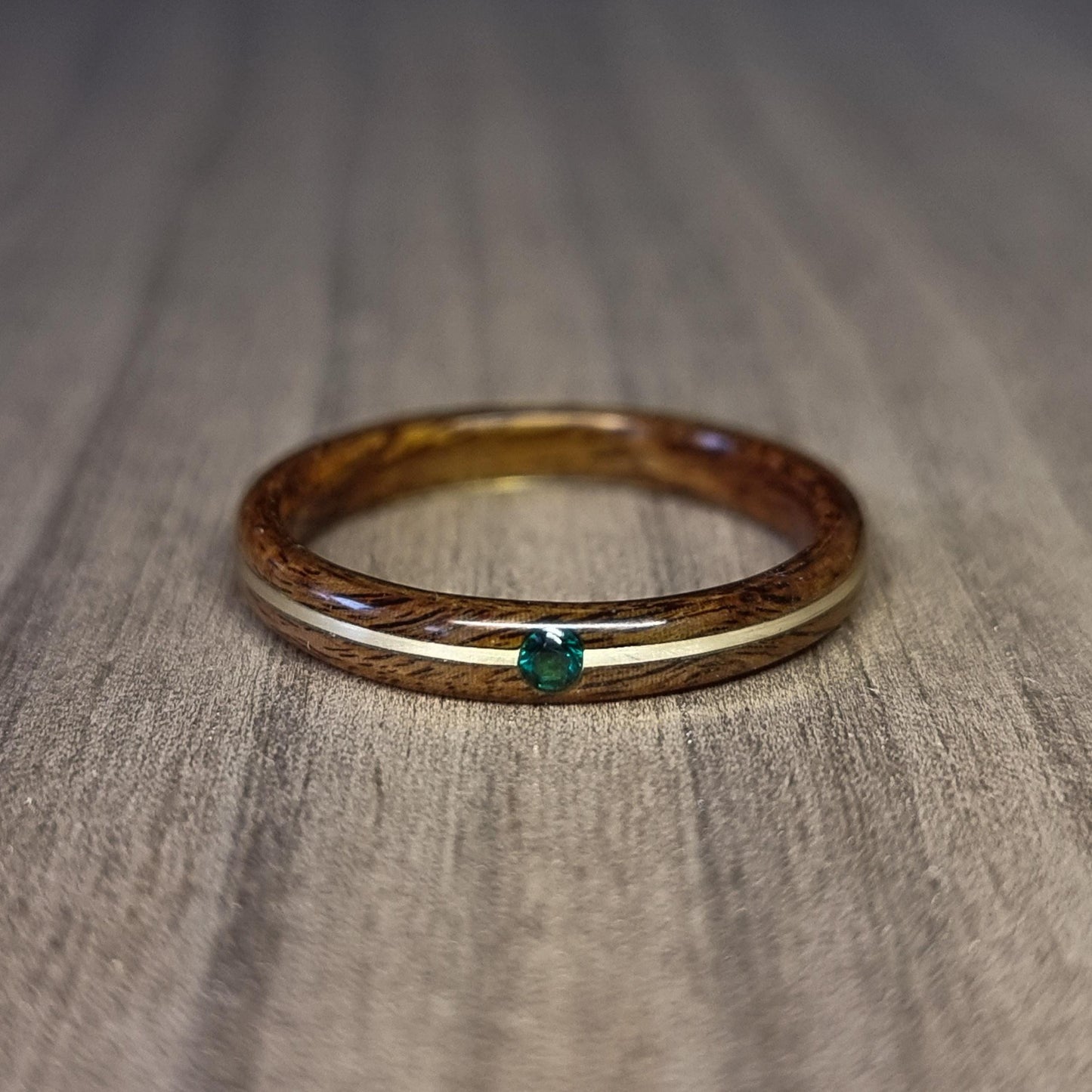 Rosewood and sterling silver with lab created emerald hand made bent wood ring