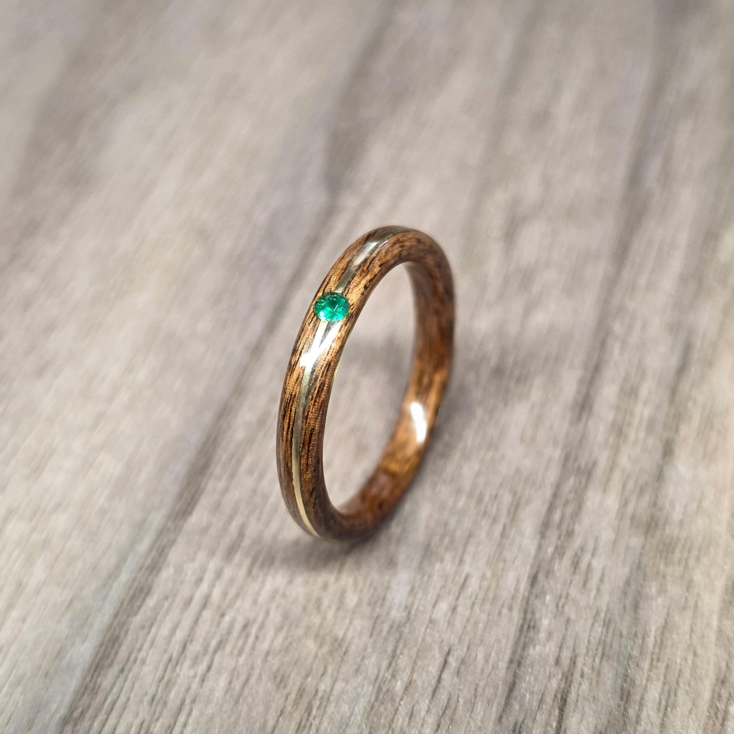 Rosewood and green tulipwood with brass and lab created emerald hand made bent wood ring